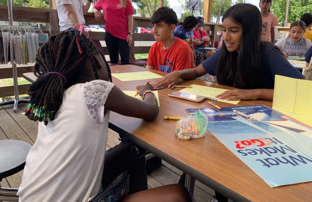 Youth coloring worksheets at an outdoor workshop
