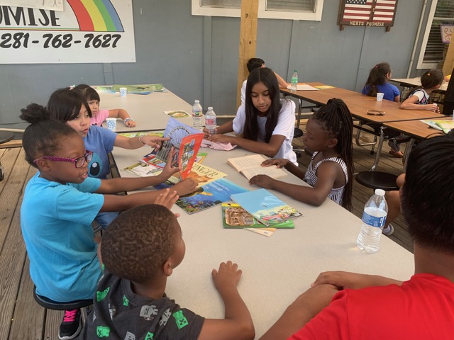 Students sharing picture books during a literacy workshop