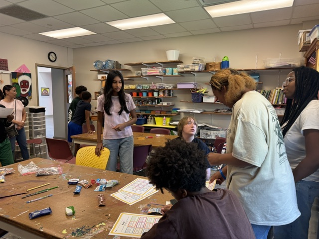 Workshop volunteers leading an activity in an art classroom